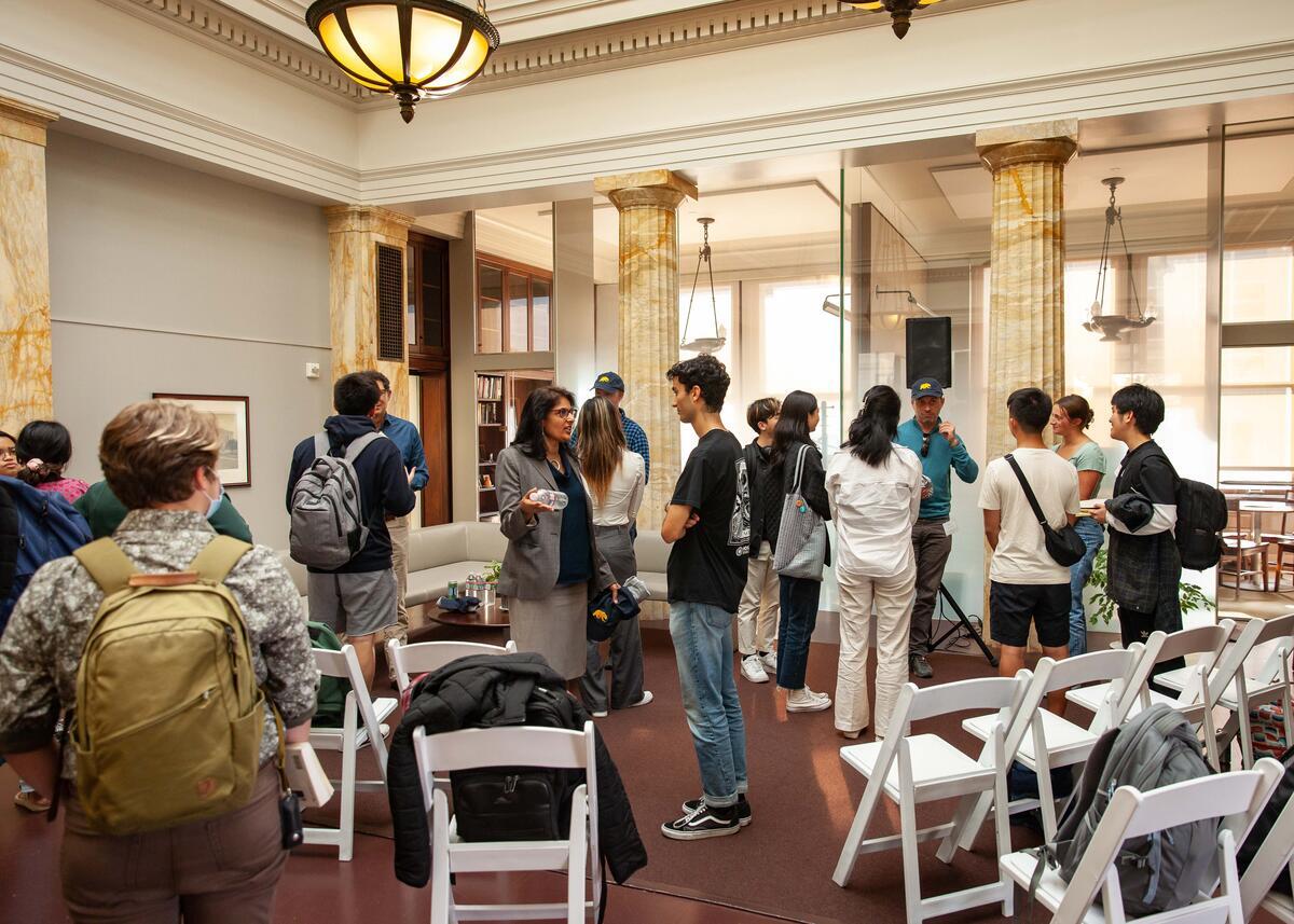 Students standing and speaking with alumni panelists