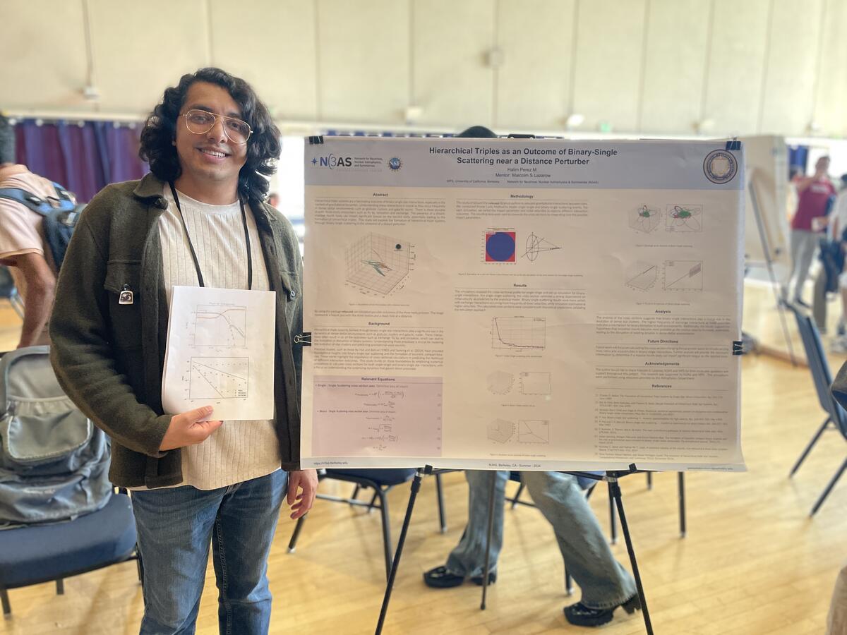 Student next to research poster